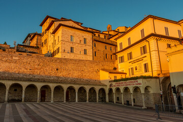 Fototapeta premium Sunset over the historic houses in the Assisi historic center, Umbria Italy