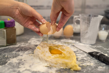 hands of a young girl preparing dough for dumplings with potatoes.