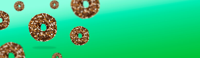 Glazed icing brown sweet sugar chocolate doughnut donut dessert on green pastel background banner. Creative minimal blurred selective focus collage food mockup concept with copy space