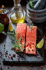 Seasoning raw salmon with salt and herbs