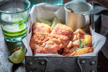 Roasted fish and chips with sauces and lime.