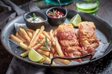 Grilled cod and potatoes with sauces and lime.