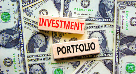 Investment portfolio symbol. Wooden blocks with concept words Investment portfolio on beautiful background from dollar bills. Business investment portfolio concept. Copy space.