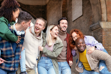 Multiracial young people walking happily on the street - Guys and girls having fun together - Lifestyle concept - Selective focus