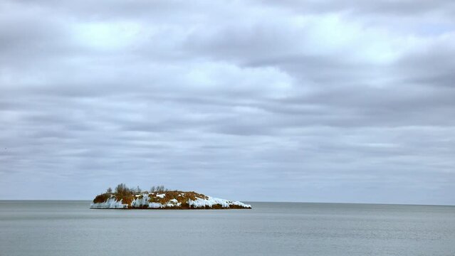  island on coast of superior lake Minnesota USA winter north shore on cloudy day