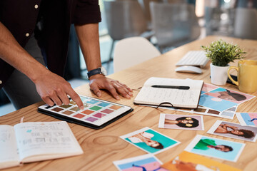 Fototapeta premium So many colours to choose from. Cropped shot of an unrecognizable businessman standing alone in his office and using a tablet to view colour swatches.