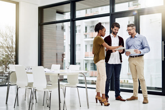They have success all figured out. Shot of a group of businesspeople having a discussion in a modern office.