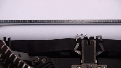 Typing phrase "2022 Ukrainian Refugee Crisis" on retro typewriter.