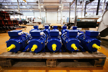 New blue electric motors in the factory for the assembling of machines