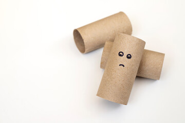Empty toilet paper roll with sad face for running out of paper on white background