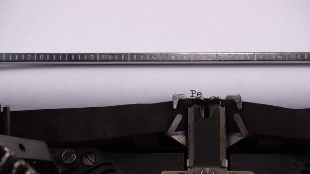 Typing phrase "Peace in Ukraine" on retro typewriter.