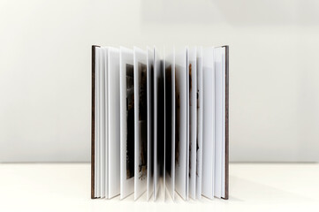 wooden photo book on a light background. metal shield. stylish and modern photo album.