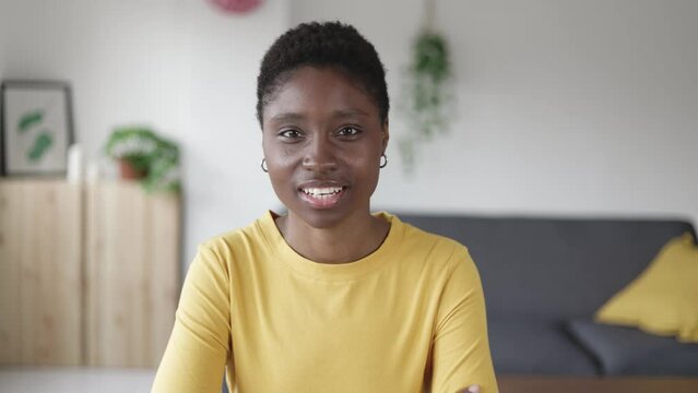 POV cheerful young african american woman talking on video conference or business online meeting on laptop from living room at home office. High quality 4k footage