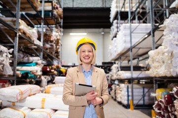 industry maintenance engineer woman wearing uniform and safety helmet under inspection and checking...