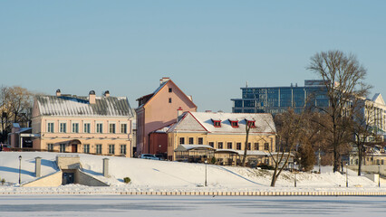 Neighborhood of old houses and modern buildings in winter. Retro versus modern style. Contrast in architecture.