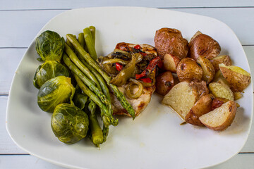 pork chop top with sauteed onions and pepprs with vegetables