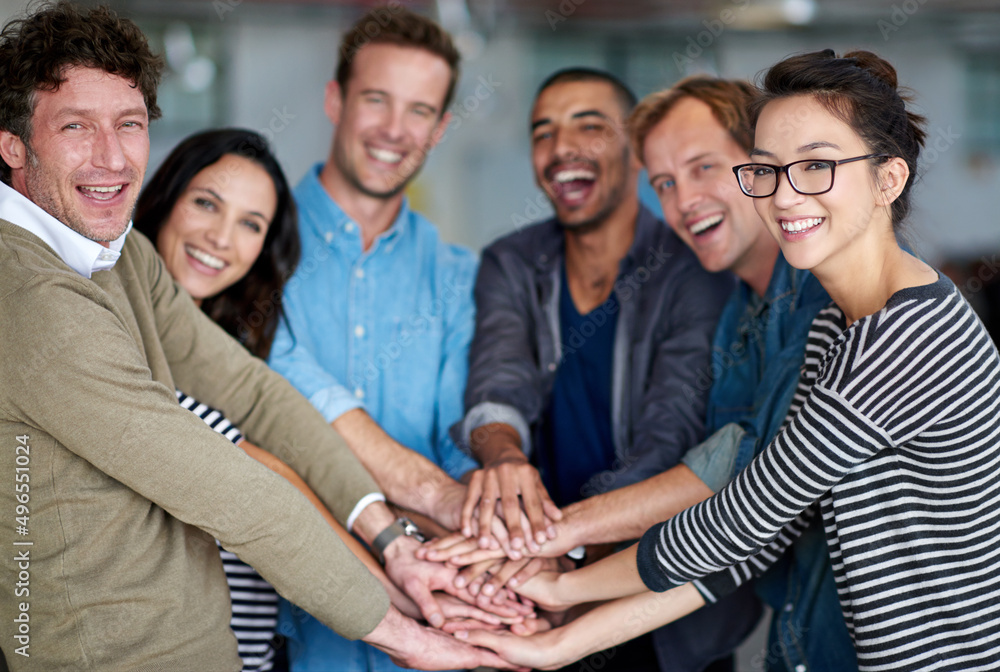 Aufkleber what a team. portrait of happy group of coworkers holding their hands together in unity.