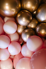 Background of pink and gold balloons. Colourful balloons.