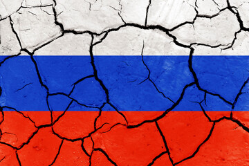 Flag of Russia and Ukraine on the texture of dry cracked earth. Relations between Ukraine and Russia