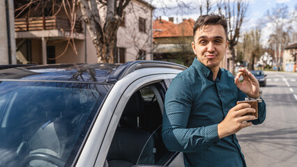 One man driver standing in front of his car drinking alcohol from flask drunk