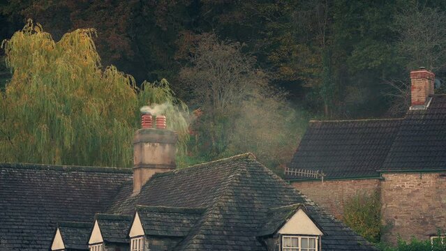 Village Scene With Smoking Chimney At Sunset
