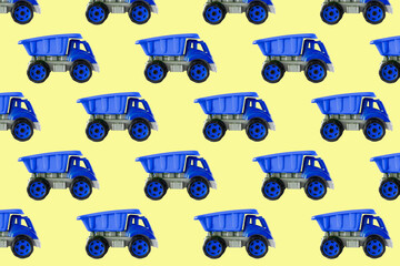 Fototapeta premium Colorful blue plastic dump truck, tip lorry, car toy isolated on yellow background still life seamless pattern,mockup, template, toys for children, boys, girls, kids development, playing, childhood