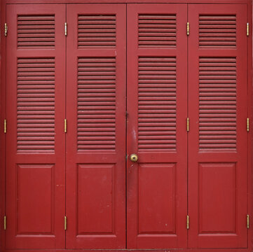 Closeup of Red wooden doors on the white walls texture pattern background.