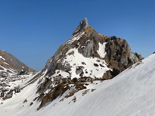 Rocky peak Dejenstogg or Dejenstock (2022 m) in the Glarus Alps mountain range, over the Klöntalersee (or Kloentalersee) reservoir lake and Klöntal alpine valley - Canton of Glarus, Switzerland