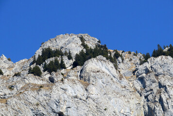 Rocky peak Dejenstogg or Dejenstock (2022 m) in the Glarus Alps mountain range, over the Klöntalersee (or Kloentalersee) reservoir lake and Klöntal alpine valley - Canton of Glarus, Switzerland