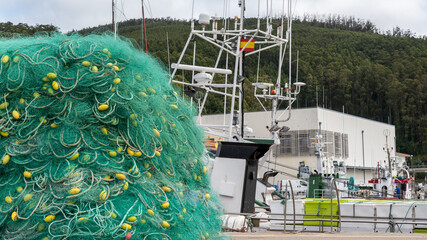 Fishing mesh with fishing boat in the background in the port
