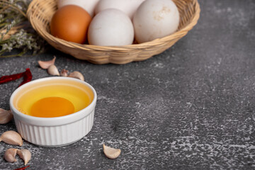 basket of fresh duck eggs on a wooden table from agriculture farm.