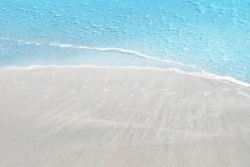 Fototapeta na wymiar Soft blue ocean wave on sandy beach for texture copy space and background