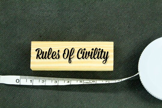 measuring tape and wooden oapan with the words rules of civility