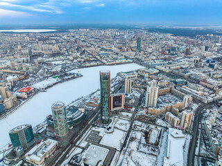 Fototapeta premium Yekaterinburg aerial panoramic view in Winter at sunset. Yekaterinburg city and pond in winter.