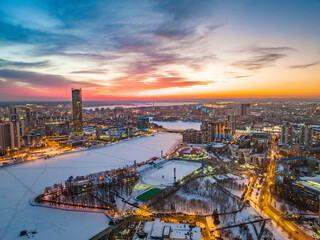 Yekaterinburg aerial panoramic view in Winter at beautiful pink and orange sunset. Yekaterinburg city and pond in winter.