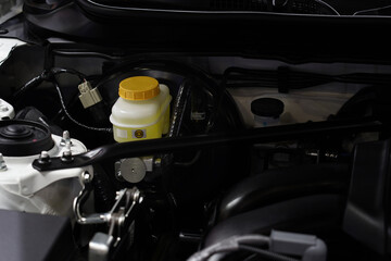 Brake fluid tank inside the Modern car engine, automotive part.