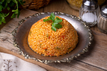 Traditional turkish bulgur pilaf with tomato sause in plate (Turkish name; meyhane pilavi)