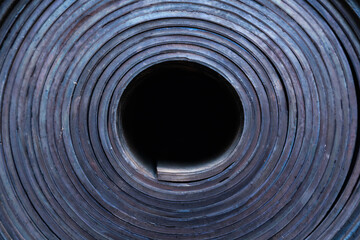 Industrial, new, black rubber twisted into a roll, close-up. - obrazy, fototapety, plakaty