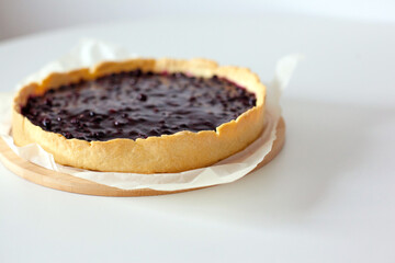 Sweet cake with black currant. Homemade pie with summer berries on a white table. side view from above. Tasty baked sweets. 