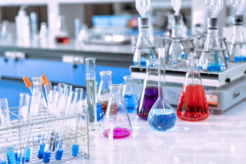 glass flask in chemical science education laboratory with molecular structure in blue background