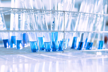 glass flask in chemical science education laboratory with molecular structure in blue background