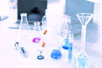 glass flask in chemical science education laboratory with molecular structure in blue background