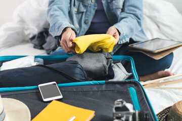 women organize her luggage prepare stuff for travel.