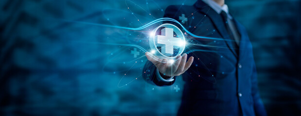 Businessman hand holding virtual medical health care icons with medical network connection. People health care awareness rising growth of medical health and life insurance business.