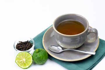 Bergamot tea or Earl Grey tea in ceramic cup and fresh bergamot fruit with sliced isolated on white background.