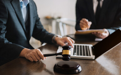Lawyer businessman and two business partners working together in office. Businessmen sitting at desk and making notes.