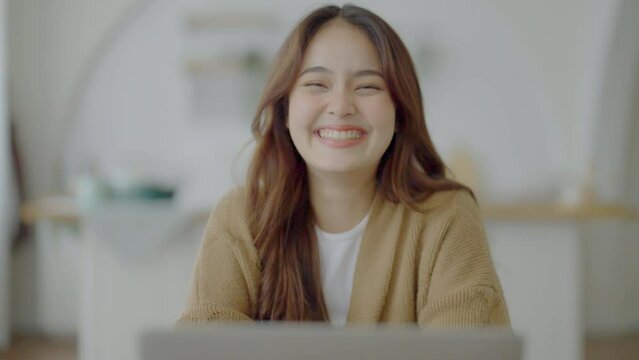 Portrait smiling asian young woman looking to camera. Facial expression happy