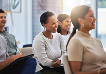 The journey towards success. Shot of a group of employees laughing during a meeting at work in a modern office.