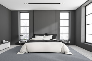 Grey bedroom interior with bed on carpet, panoramic window on city view