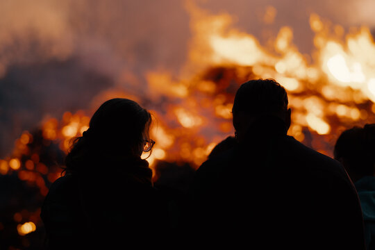 silhouette of people in front of easter bonfire